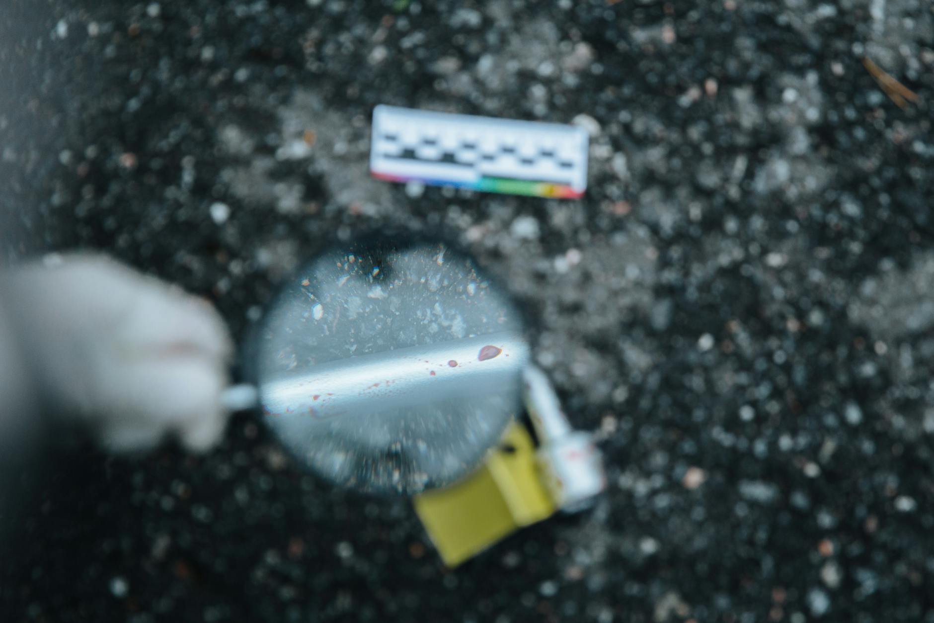 blurred shot of a hand holding magnifying glass