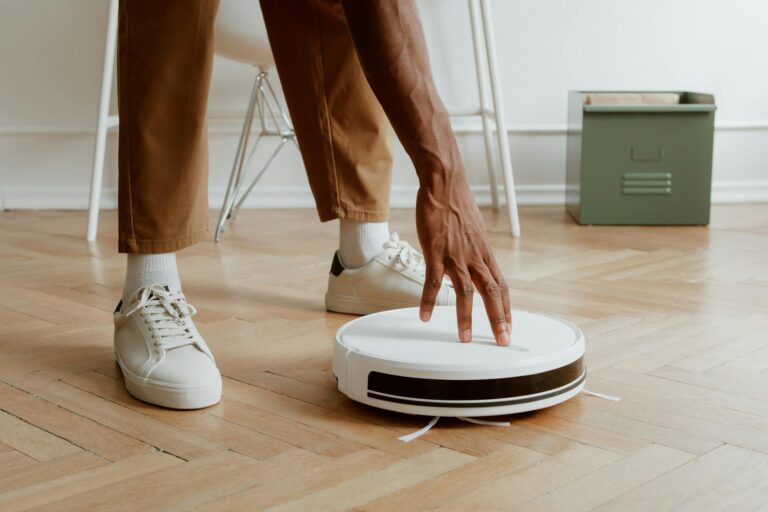 man touching cleaning robot